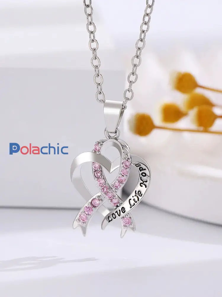 Sensibilisation au cancer du sein des femmes Collier ruban rose comme image / ONE